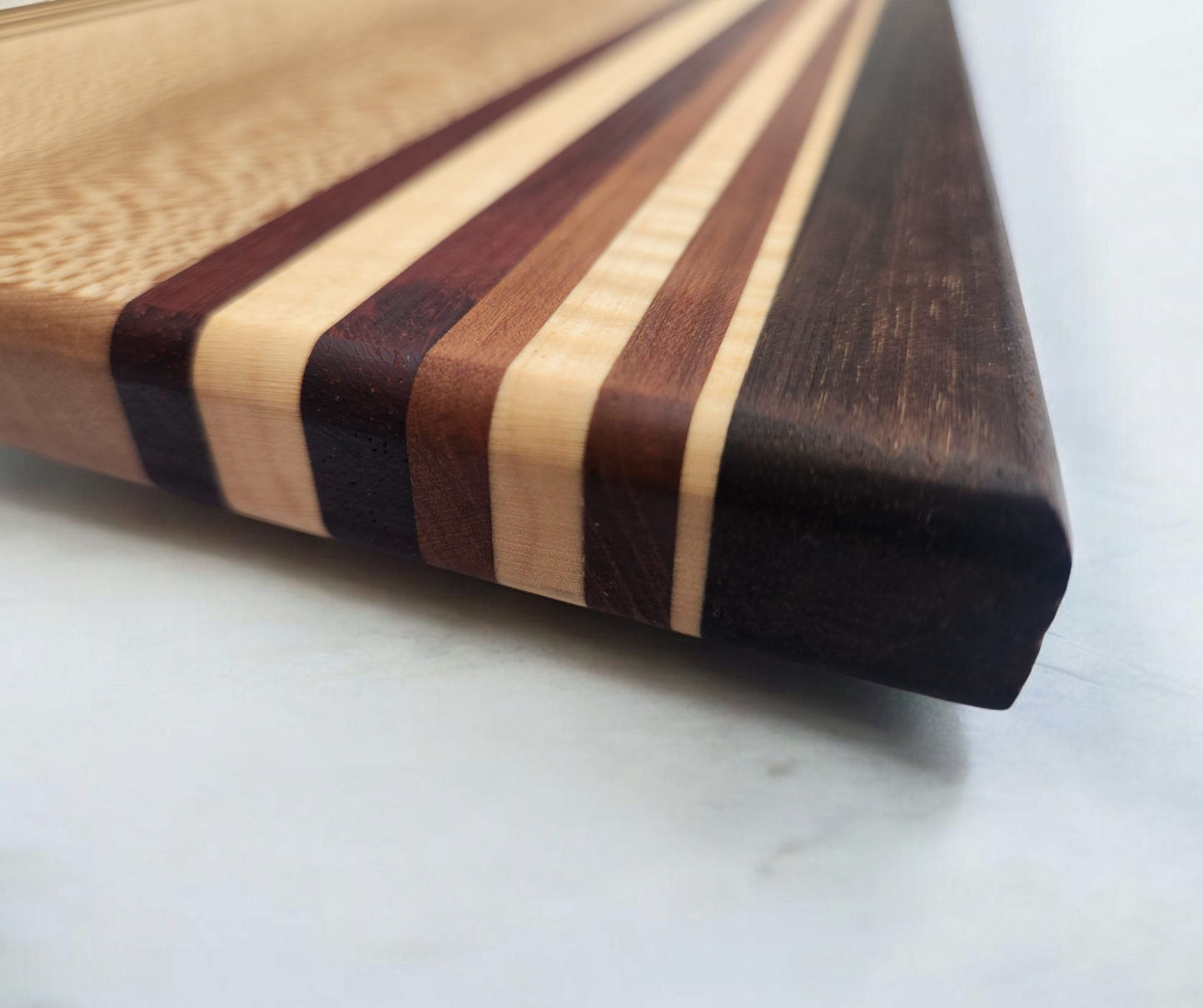 Figured Sycamore, Peruvian Walnut, Cherry, Maple & Blood Wood Cutting Board